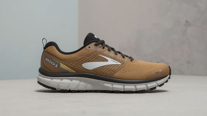 What are the Top 5 Best Trail Running Shoes? Side view of a brown and black trail running shoe with a white logo and thick white cushioned sole, placed against a neutral background.