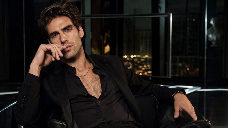 Top 5 Famous Male Models of All Time Jon Kortajarena in a sleek black suit, cinematic lighting highlighting sharp features and luxury fashion editorial elegance
