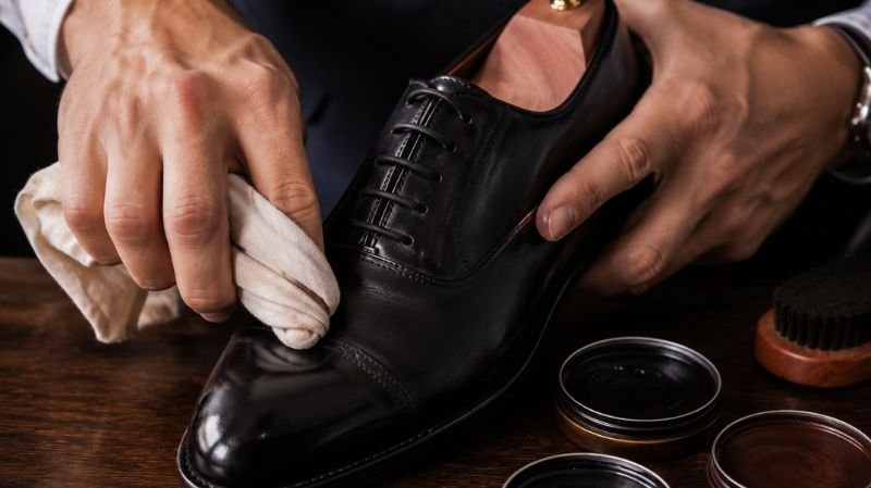 Applying shoe cream to leather shoes
